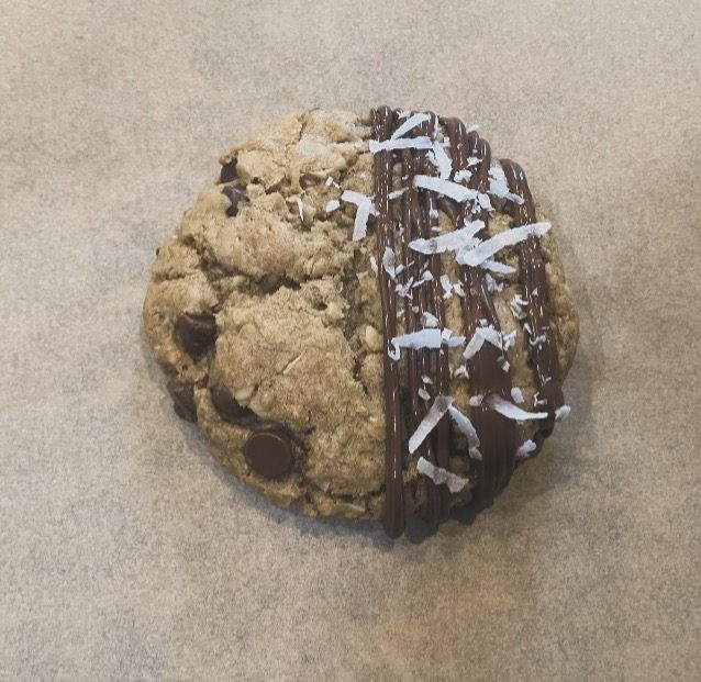 A jumbo cookie half dipped in chocolate and finished with coconut