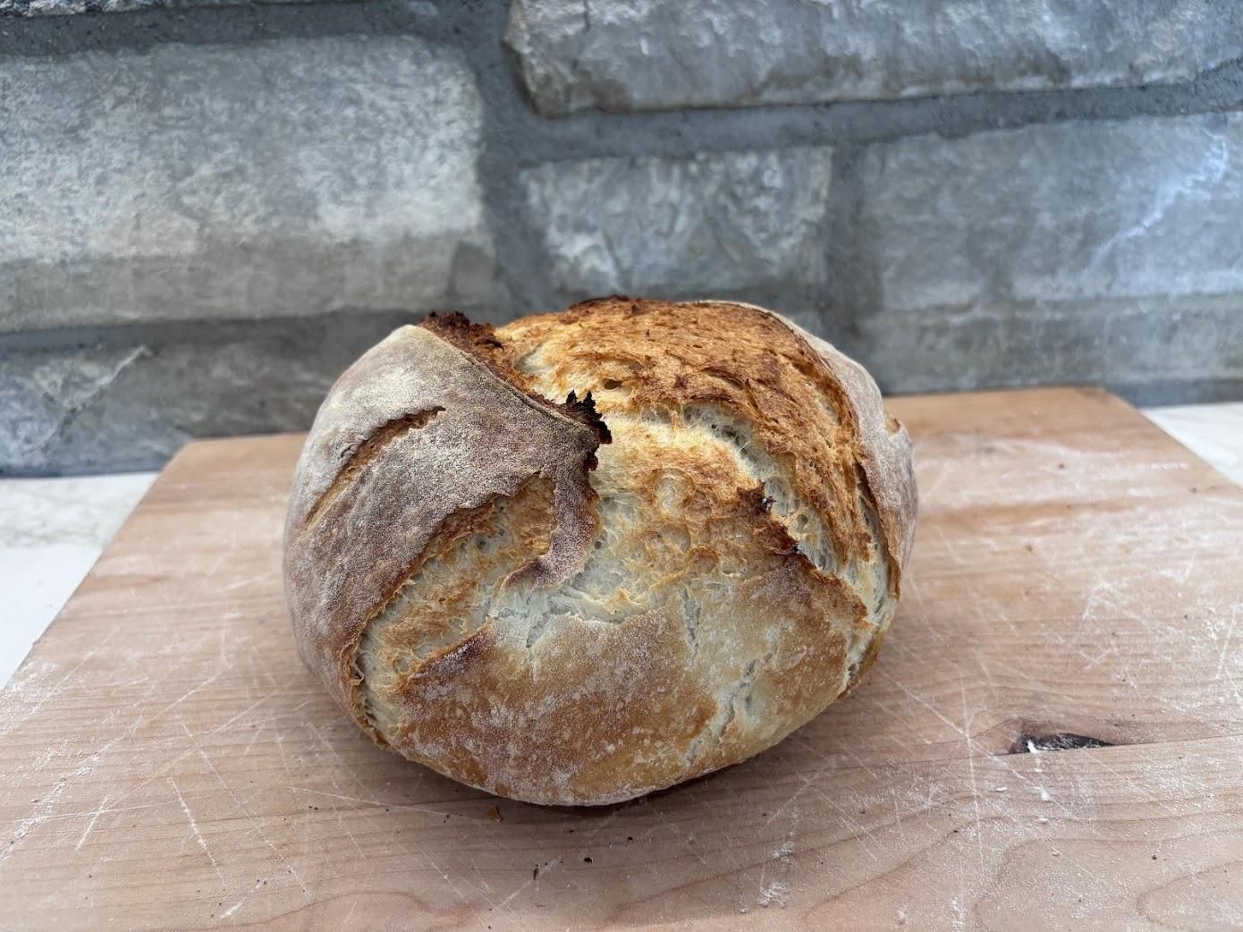 Round white artisan loaf with a rustic crust