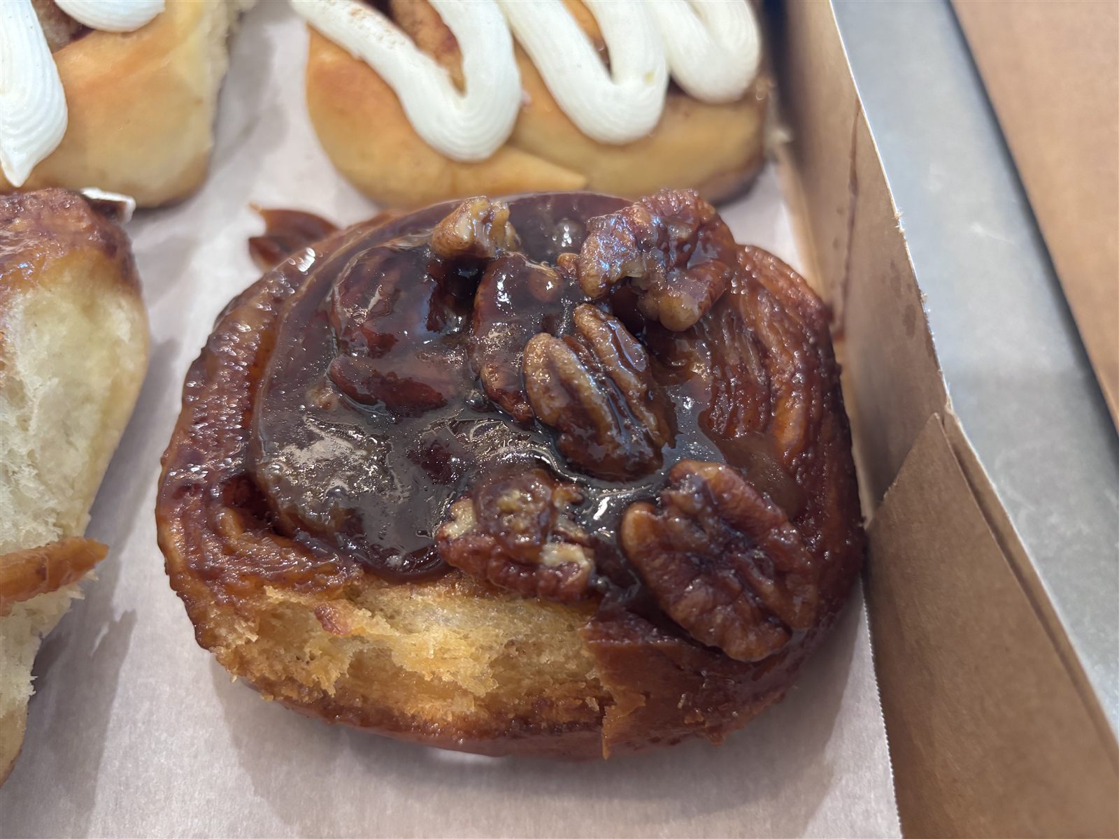 A pecan sticky bun glazed in caramel